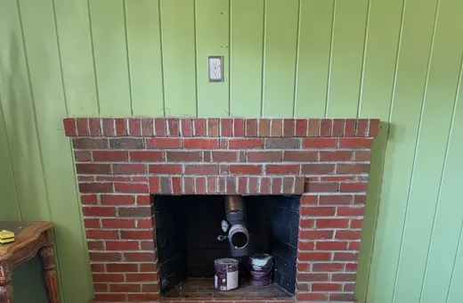 Custom-built fireplace with hearth and firebox surround, constructed from the ground up for a wood-burning stove