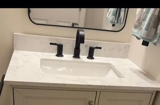 New bathroom vanity installed flush to the wall after cutting back the tile for a clean, sealed fit