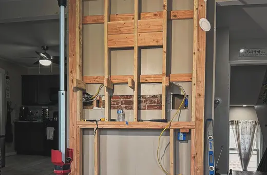 Custom bump-out fireplace framed on a solid foundation with precise, reinforced framing