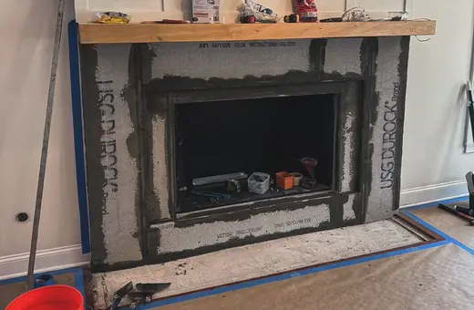 Custom fireplace prep work with backer board installed and corners reinforced ahead of tiling