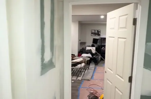 Basement renovation in Somerset, NJ with drywall taped, a new door installed, and ready for sanding and primer