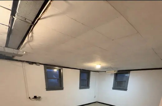 Basement walls scraped, sealed, and refreshed, with a new graspable railing added for safety and code compliance