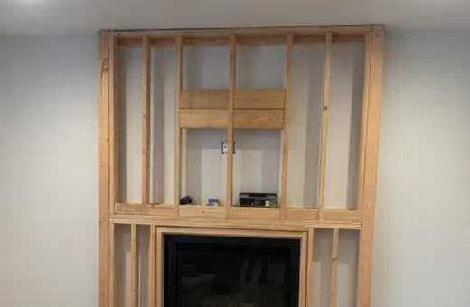 Fireplace wall framed from the studs out, squared and reinforced to support the finished surround